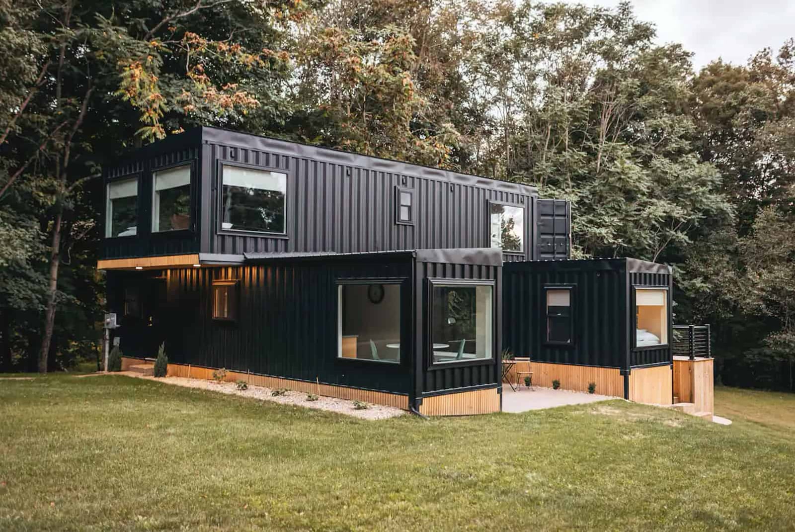 Illustrative reference of a dark-clad residence beneath mature trees