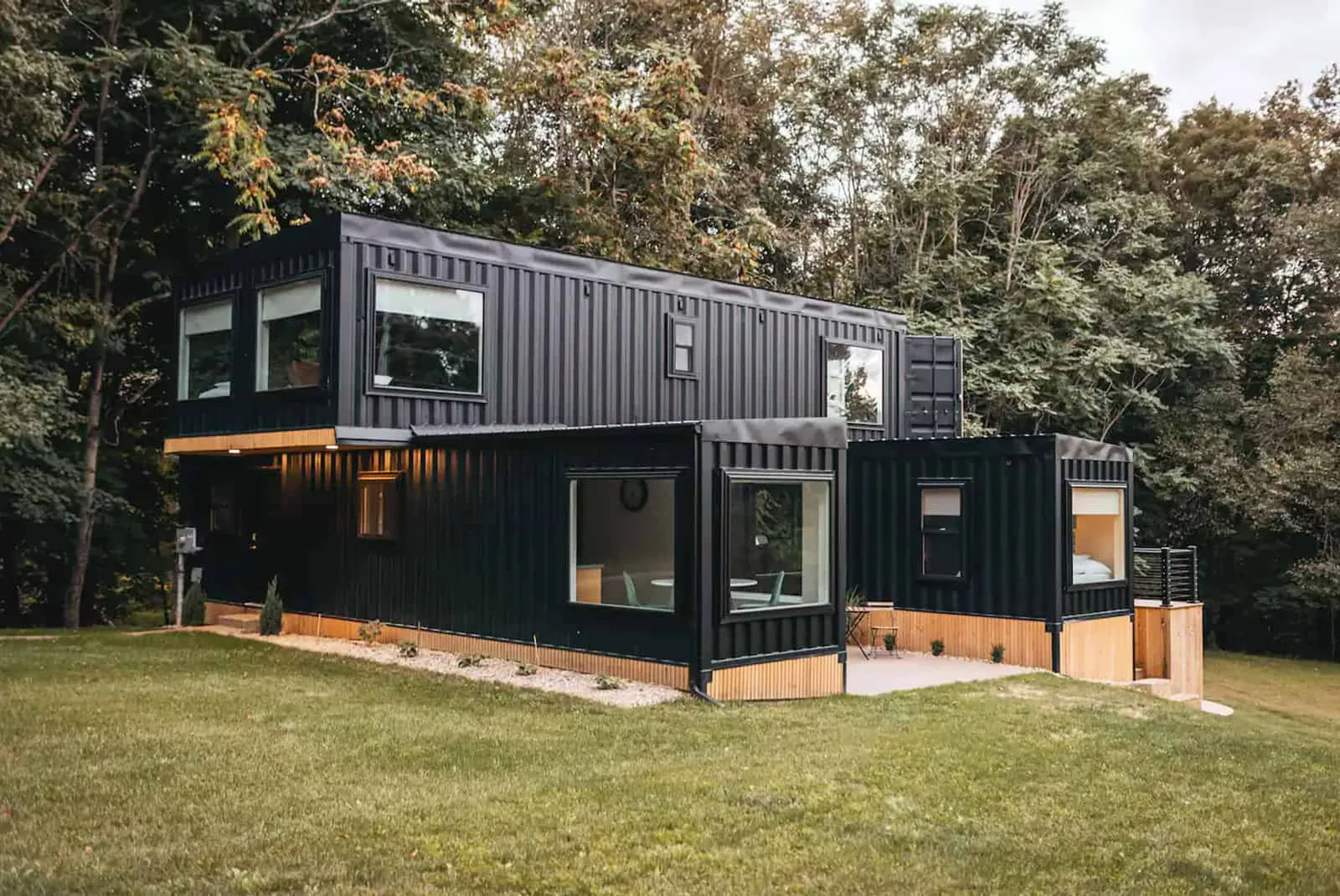 Illustrative reference of a dark-clad residence beneath mature trees